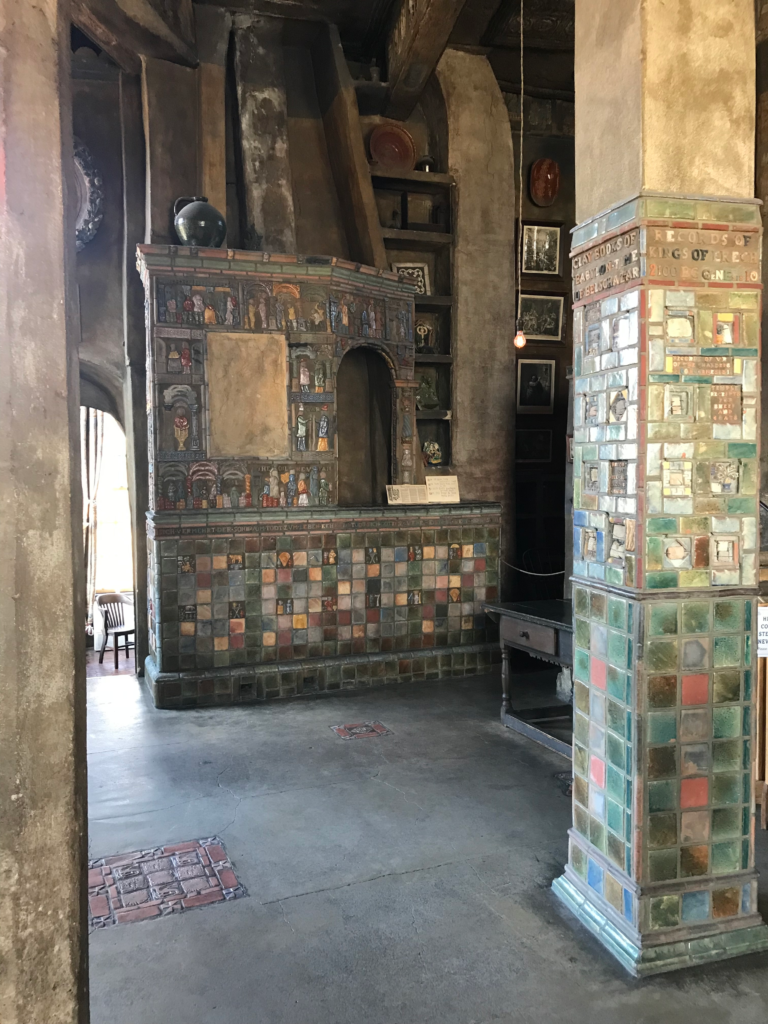 Colorful tiled fireplace and column inside Fonthill Castle with decorative ceramic details