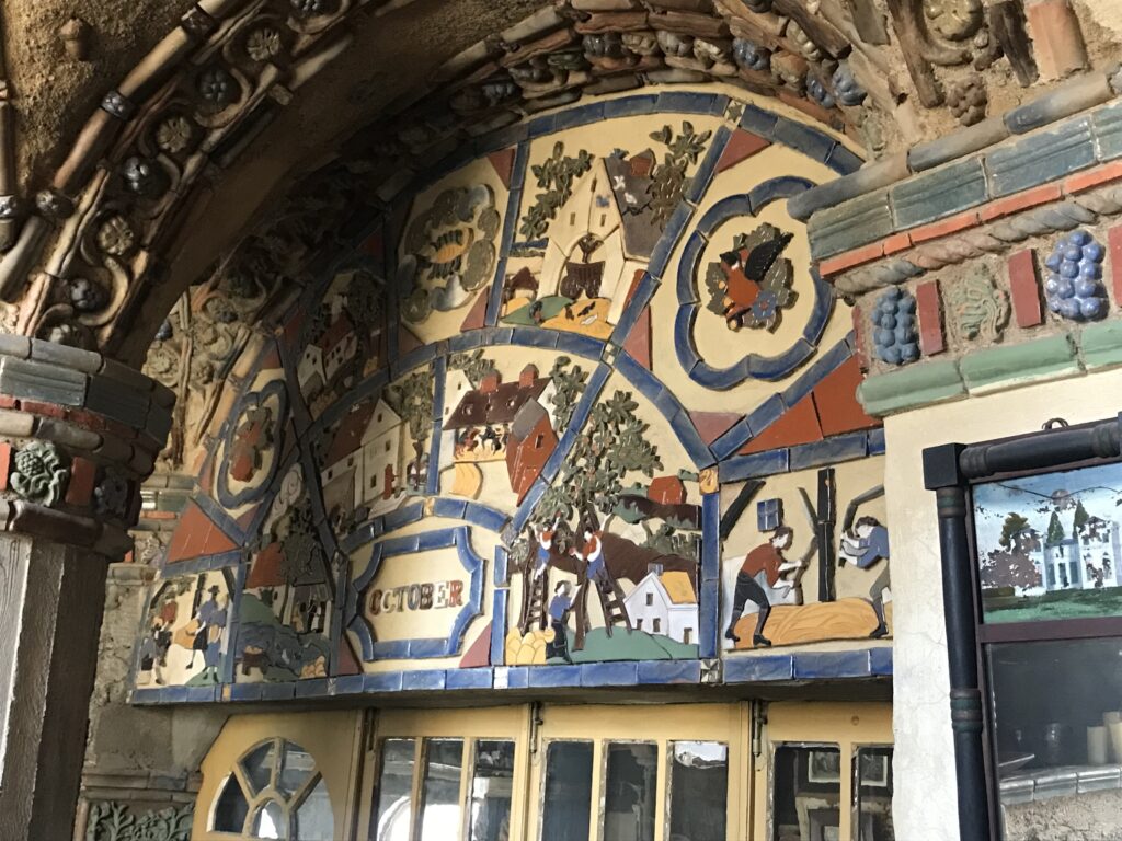 Decorative tile mural inside Fonthill Castle depicting seasonal scenes and the word October