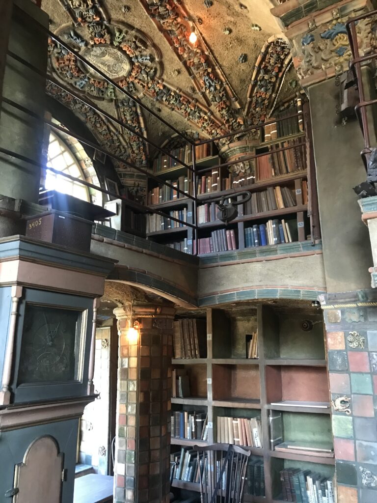 Library interior with bookshelves and ornate tiled ceiling inside Fonthill Castle in Doylestown Pennsylvania