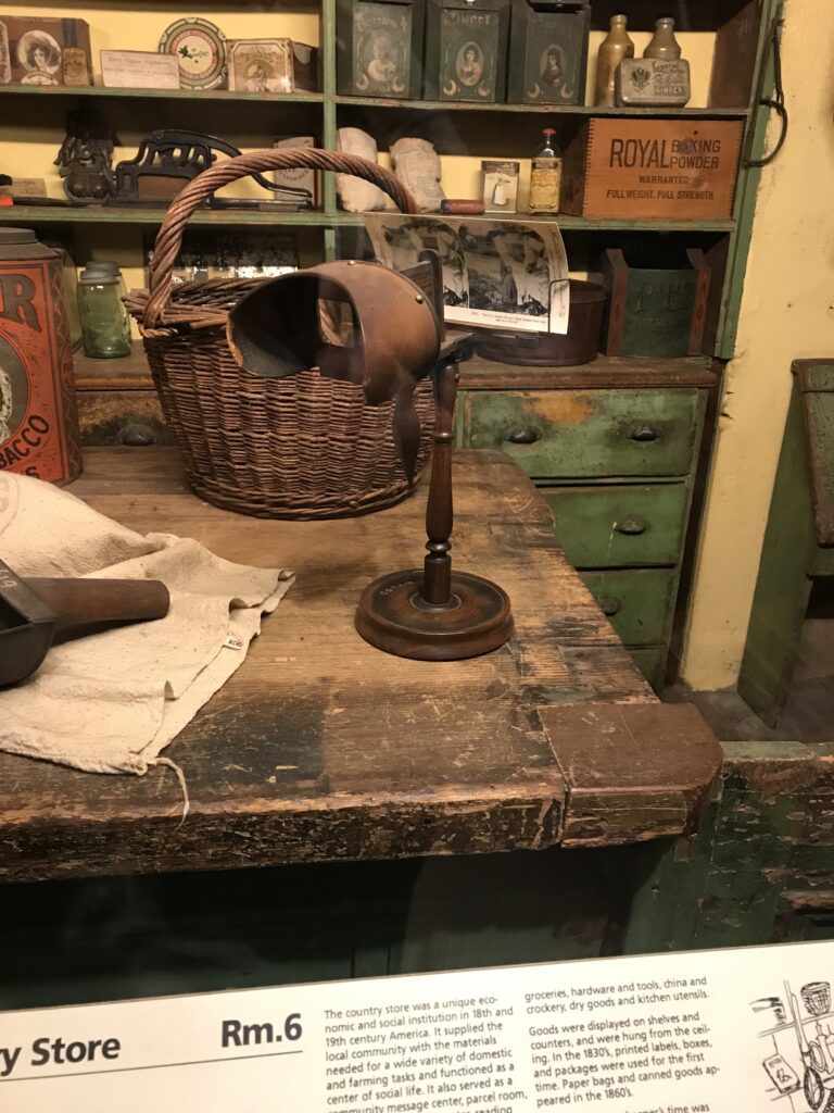 Antique stereoscope viewer on wooden stand displayed in a recreated country store at the Mercer Museum