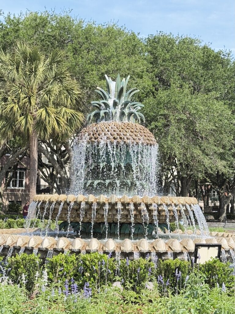 Pineapple Fountain in Waterfront Park with water cascading and palm trees in the background