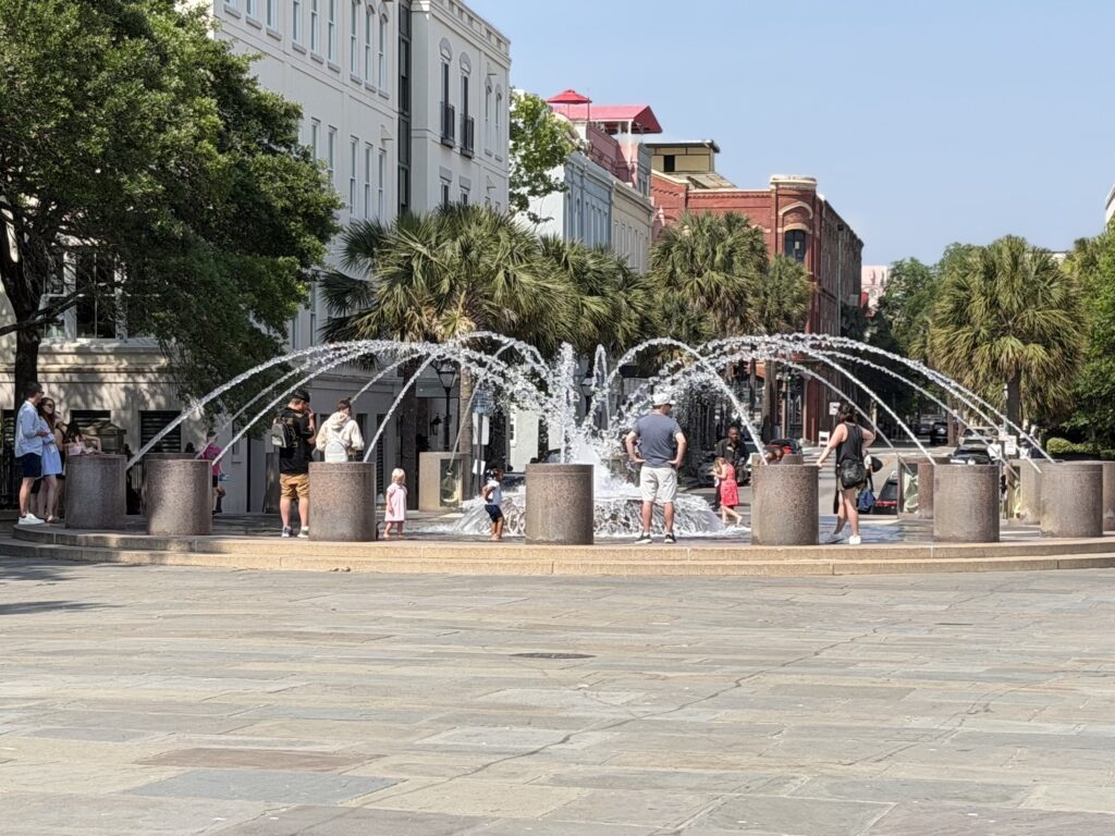 Visitors enjoying the splash fountain at Waterfront Park in downtown Charleston SC