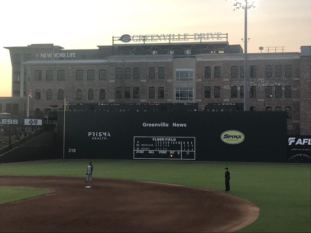 Outfield view at Fluor Field in Greenville South Carolina with Greenville Drive sign at sunset