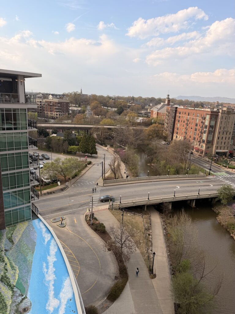 Downtown Greenville South Carolina with bridge over the Reedy River and city buildings