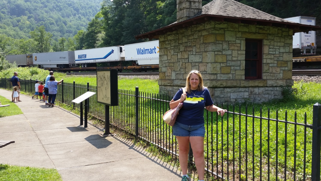 Standing near the fence at Horseshoe Curve in Altoona, Pennsylvania as a freight train passes through the mountains