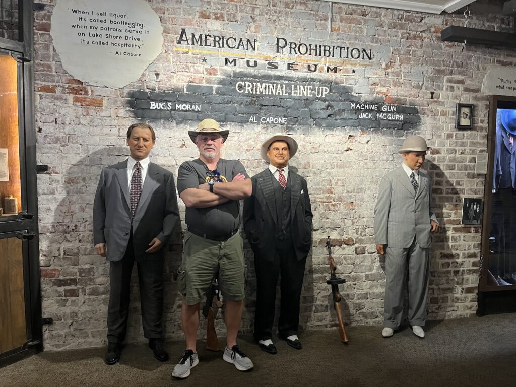 Visitor posing with gangster figures at the American Prohibition Museum