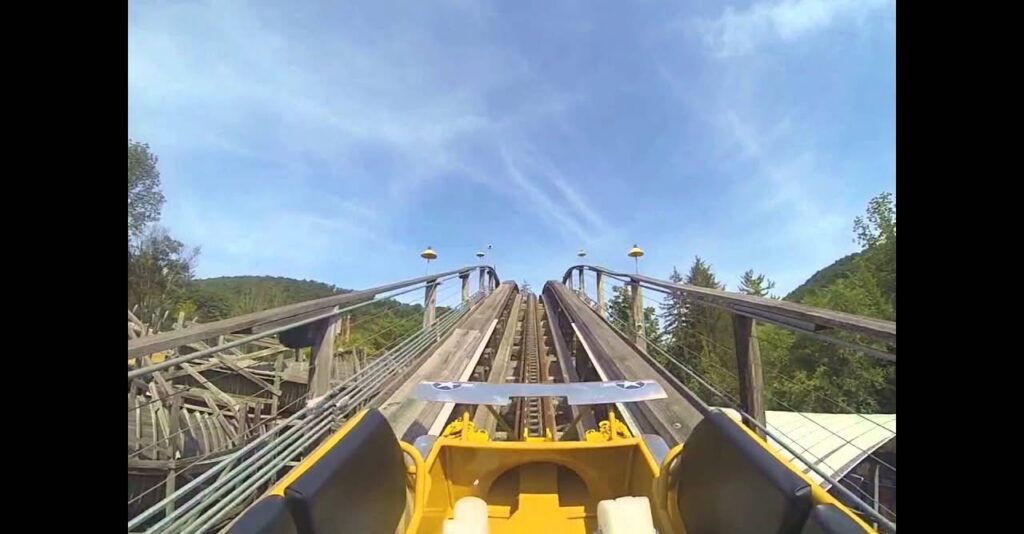 Front-seat view climbing a hill on the Flying Turns wooden bobsled roller coaster at Knoebels Amusement Resort.