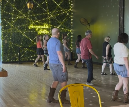 Participants learning a line dance at Honeysuckle Holler in Hendersonville, North Carolina.