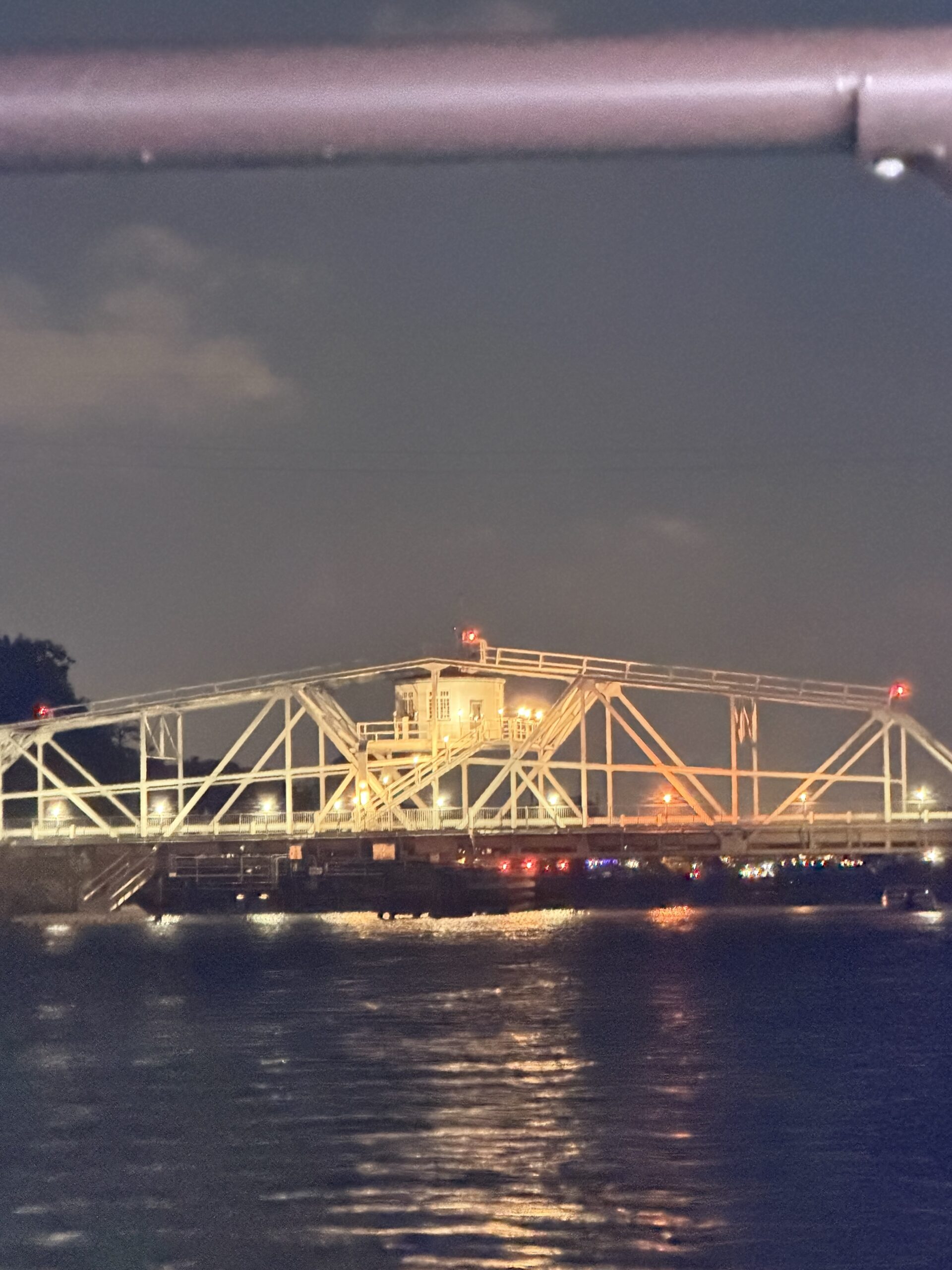 Little River swing bridge illuminated at night along the Intracoastal Waterway.