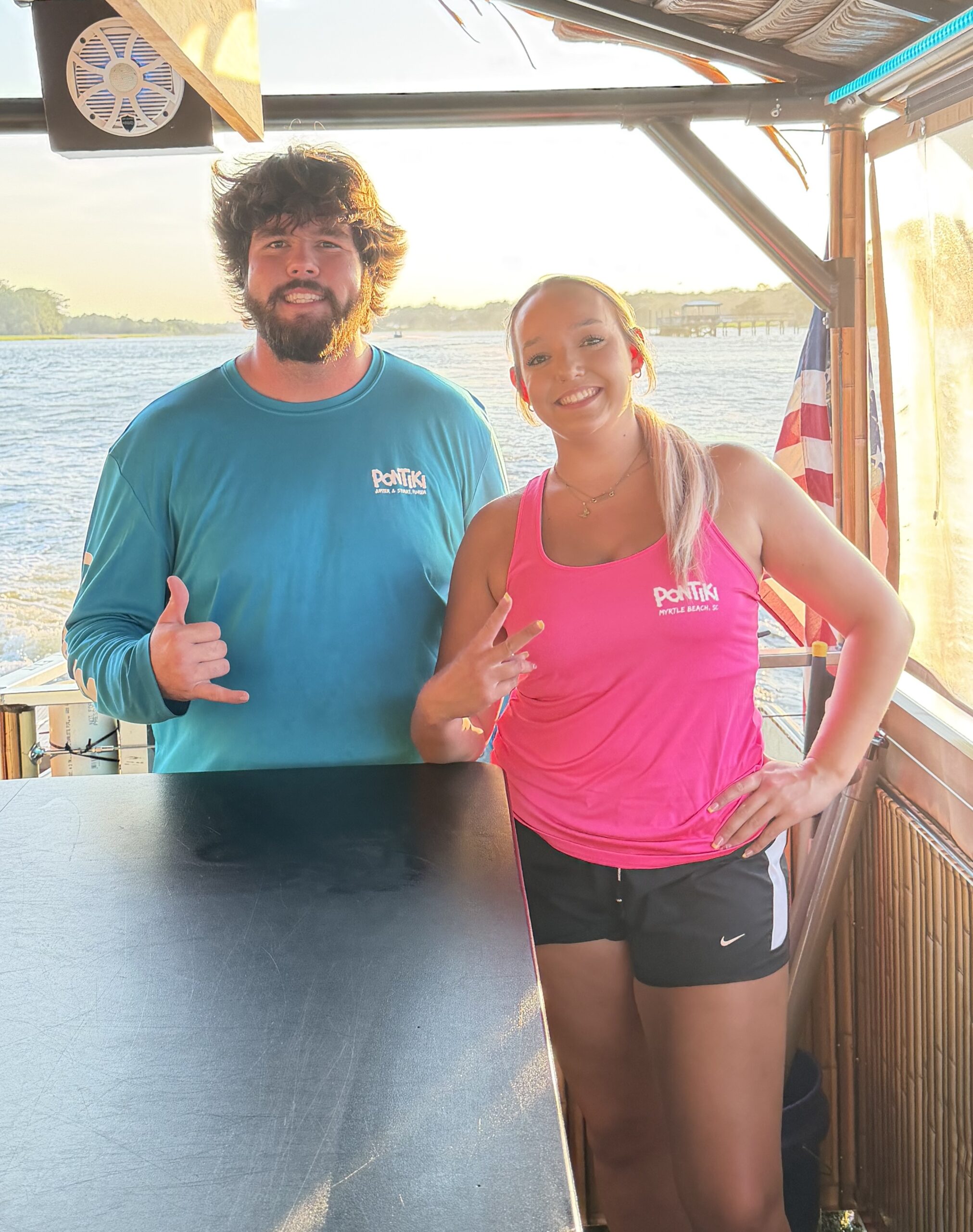 Friendly PonTiki crew members welcoming guests aboard the sunset cruise.