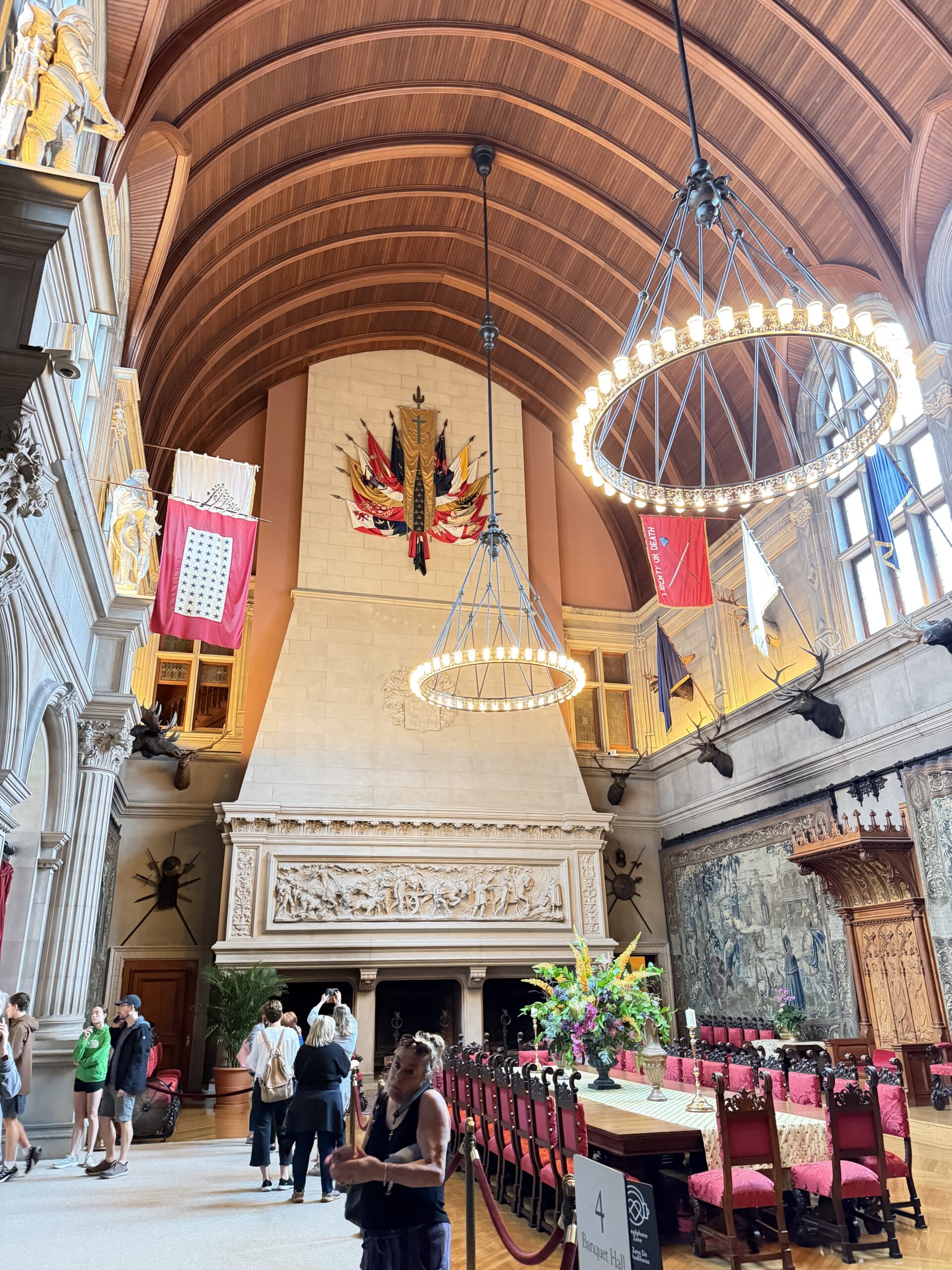 Biltmore House Banquet Hall with barrel ceiling, flags, and long dining table