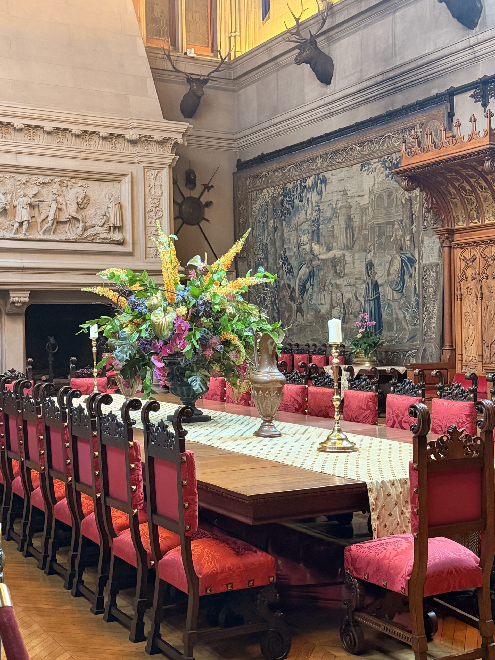 Table setting in the Biltmore Banquet Hall with red upholstered chairs