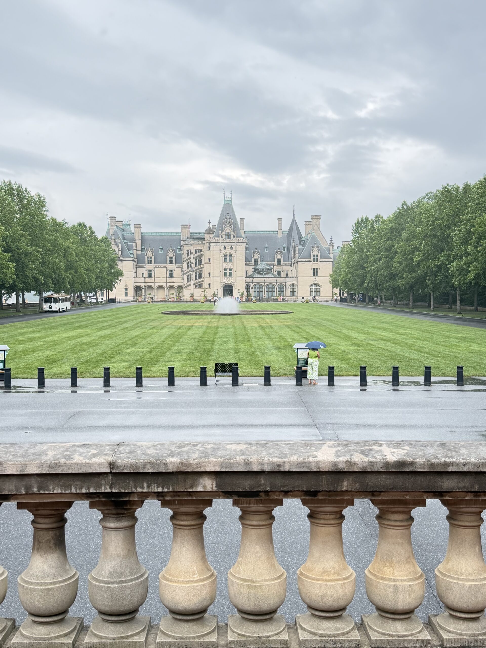 Biltmore House viewed from the esplanade fountain lawn under a cloudy sky