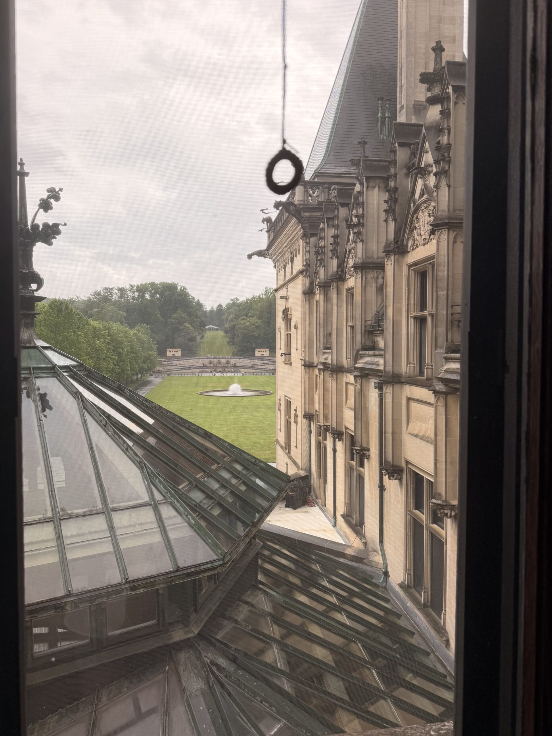 View of the lawn and fountain from a rooftop-level window at Biltmore House