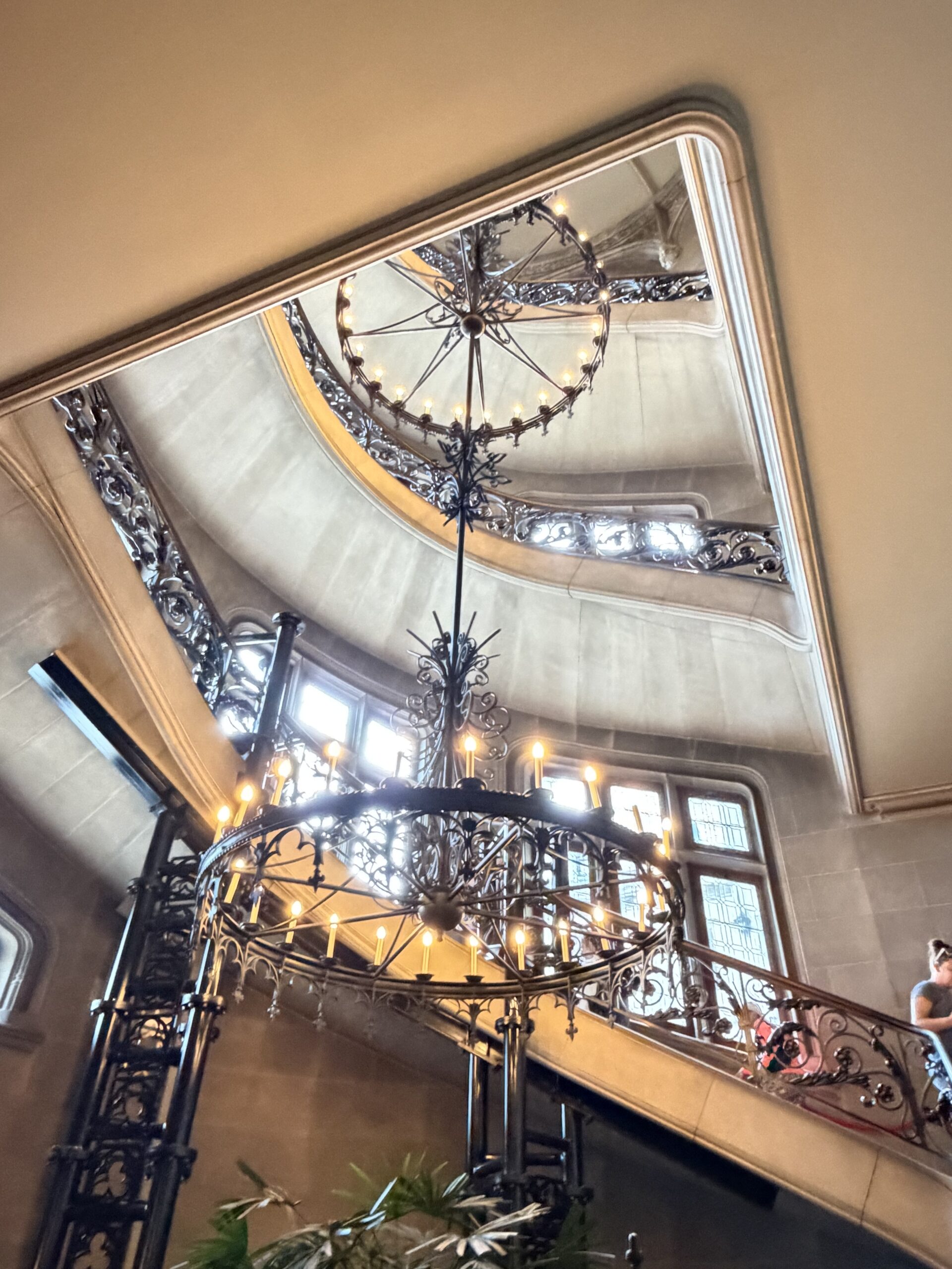 Wrought-iron chandelier hanging through Biltmore House's four-story spiral staircase